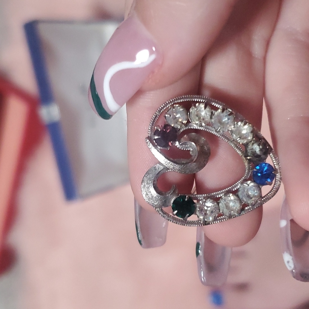 silver jeweled brooch